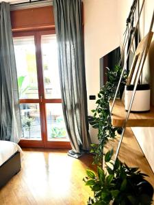 a living room with a sliding glass door and plants at Ecosuite your design Escape in Rome