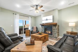 a living room with leather furniture and a fireplace at Near Indoor & Outdoor Pools: Hot Tub, Game Room & Free SDC Tickets in Kimberling City
