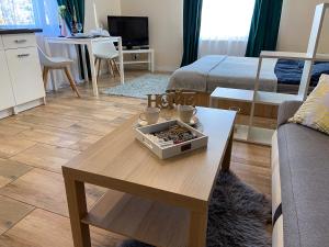 a living room with a coffee table and a couch at Mokka Apartament in Warsaw