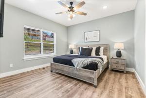 a bedroom with a bed and a ceiling fan at Near Indoor & Outdoor Pools: Hot Tub, Game Room & Free SDC Tickets in Kimberling City +100 photos