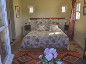 a bedroom with a bed and flowers on it at le Clos in Chambourg-sur-Indre