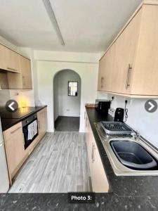 a kitchen with a stove and a sink in it at Quayside East 2 Bed in Heaton