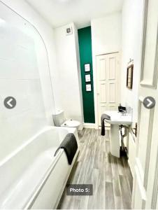 a bathroom with a tub and a toilet and a sink at Quayside East 2 Bed in Heaton