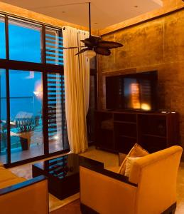 sala de estar con ventilador de techo y TV en Hotel "ala Residencias", en Chetumal