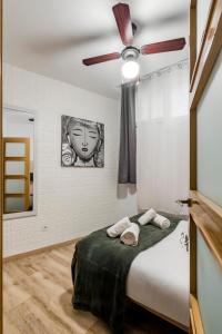 1 dormitorio con 1 cama y ventilador de techo en Charming Madrid Numancia, en Madrid