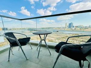 a balcony with a table and chairs and a view of the city at contemporary and cozy living in Dubai