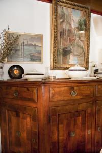 a wooden cabinet with plates on top of it at Hotel San Fantin in Venice