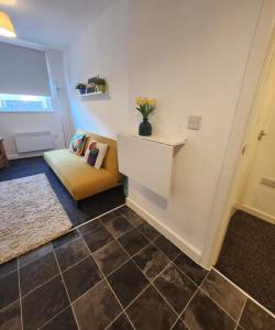 a living room with a couch and a table at Charming 1Bed Apt with Street Parking in Liverpool