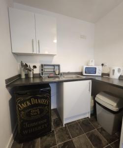 a kitchen with a counter with a sink and a microwave at Charming 1Bed Apt with Street Parking in Liverpool