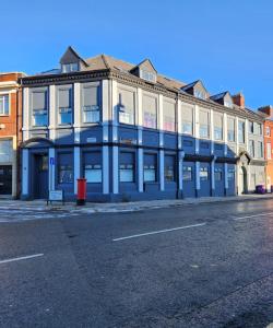 a blue and white building on the side of a street at Charming 1Bed Apt with Street Parking in Liverpool