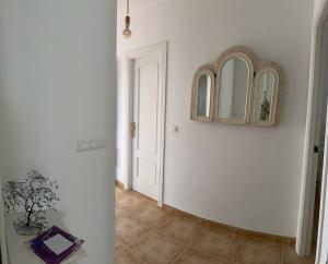 a hallway with a door and a mirror on the wall at Tiyoweh in Nerja
