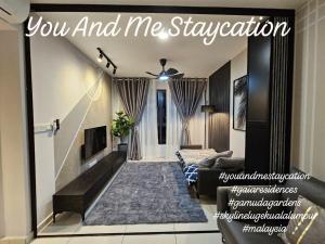a living room with a couch and a fireplace at You And Me Staycation in Rawang