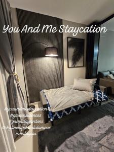 a bedroom with a bed with a mirror at You And Me Staycation in Rawang