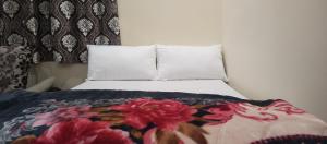 a bedroom with a bed with a flower blanket at The Beatrix Resort & Wellness in Lucknow