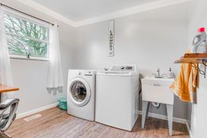 a laundry room with a washing machine and a sink at Cozy Richmond Home with Fire Pit Walk, Bike and More! in Richmond