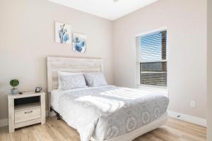a white bedroom with a bed and a window at Timber's Edge in Kimberling City +56 photos