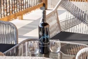 a bottle of wine sitting on a table with two glasses at Timber's Edge in Kimberling City
