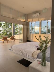 una camera da letto con un letto e un vaso di fiori su un tavolo di Villa Infinity a Lovina
