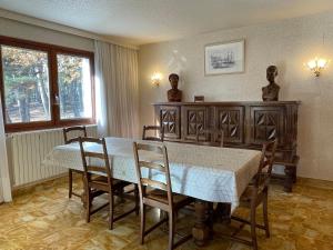 a dining room with a table and chairs and a window at Villa Caprice à l'orée des bois in Aspres-sur-Buëch +22 photos