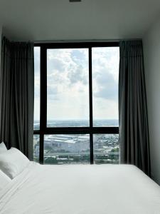 una camera con un letto e una grande finestra di HMJ1 Entire Apt on 31th floor in Khonkaen city center a Ban Si Than