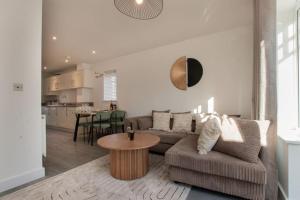 a living room with a couch and a table at Charming Colchester House in Colchester