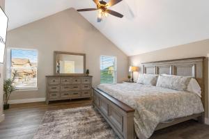 a bedroom with a bed and a ceiling fan at Sunset Bluff at Table Rock Lake in Kimberling City +98 photos