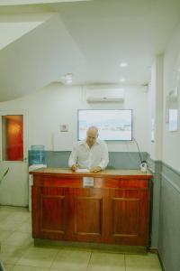 a man standing at a counter in a kitchen at Alma Mendoza Hotel in Mendoza