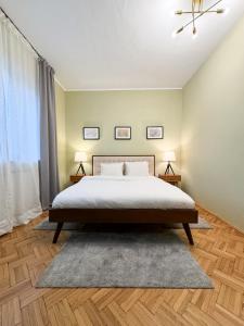 a bedroom with a large bed and two lamps at Kesletz House in Sibiu