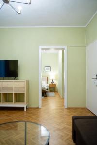 a living room with a television and a couch at Kesletz House in Sibiu