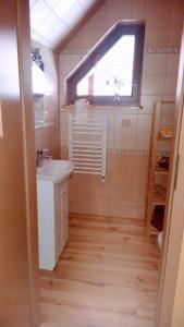 a bathroom with a sink and a window at Enklawa Spokoju 