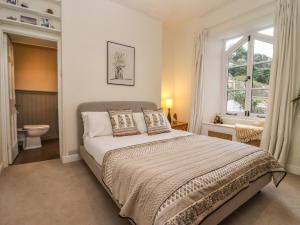 a bedroom with a bed and a window at Mount Lebanon in Clevedon