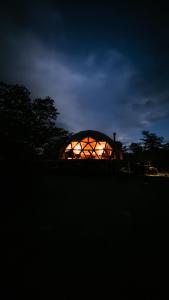 a lit up orb in a field at night at Estancia Patagonia El Calafate - Pristine Luxury Camps in El Calafate