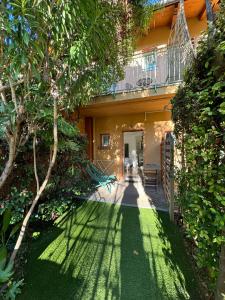 a house with a green yard with a balcony at Hotel Pavillon Imperial in Menton