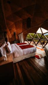 a bedroom with a bed in a room with windows at Estancia Patagonia El Calafate - Pristine Luxury Camps in El Calafate