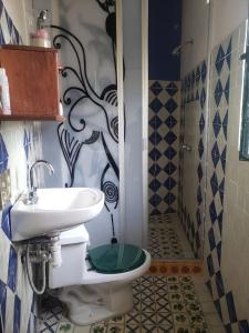 a bathroom with a toilet and a sink and a shower at Casa Jardín del Tuito in El Tuito