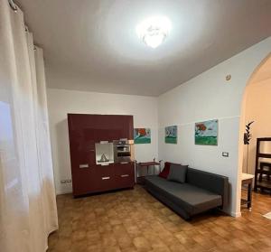 uma sala de estar com um sofá e uma cozinha em Sweet Home em Concordia Sagittaria