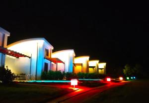 a lit up building at night with at Aurora Suites in Nea Fokea