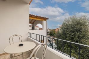 a balcony with a table and chairs and a view at B&B Antico Telaio in Santa Maria Navarrese