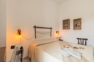 a bedroom with a bed with two towels on it at B&B Antico Telaio in Santa Maria Navarrese
