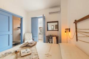 a bedroom with a bed and a mirror and a window at B&B Antico Telaio in Santa Maria Navarrese