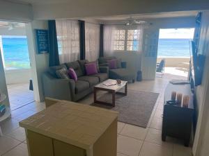 un soggiorno con divano e tavolo di Purple Rain - Direct Beach Access, 2 Bedroom, 2 Terrace Holiday Home Bliss a Saint Peter