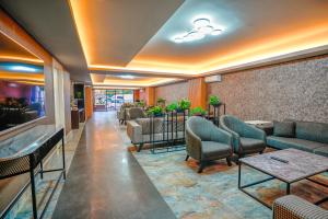 a waiting room with couches and tables in a lobby at Lupo Libero Hotel Spa in Antalya