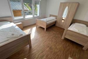 a room with two beds and a mirror at House in Sarstedt! contactless check-in in Sarstedt