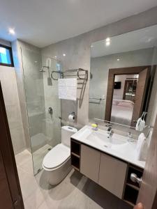 a bathroom with a toilet and a sink and a shower at NOVAPARK ILANES in Guayaquil