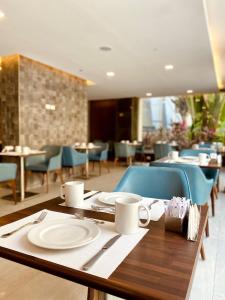 a table with plates and utensils on top at Ocean Blue Studios in Cairo