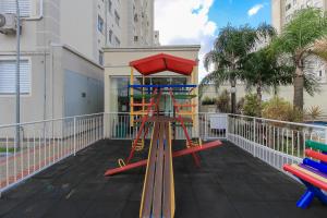a playground with a slide on a balcony at Ap Cloe com piscina próximo ao Aeroporto in Porto Alegre