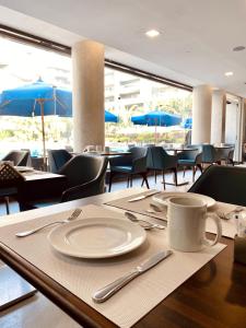 a table with a plate and a coffee cup on it at Ocean Blue Studios in Cairo