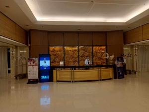 a lobby with a counter in the middle of a building at Deluxe residence in Manila