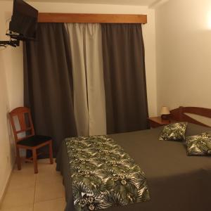 Ένα ή περισσότερα κρεβάτια σε δωμάτιο στο Hospedaria Descansa Pernas