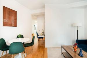 a living room with a table and green chairs at 139-2W Prime west village Furnished 2BR Best value in New York